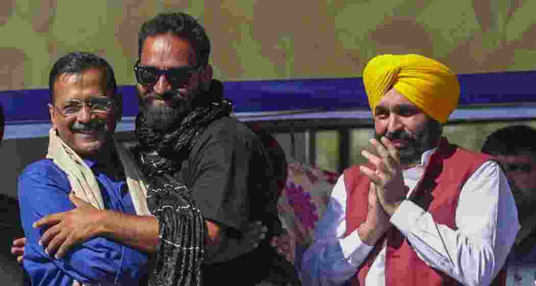 Mehraj Malik, flanked by AAP national convener Arvind Kejriwal (left), and Punjab Chief Minister Bhagwant Mann during a public meeting in Doda on October 13 last year.