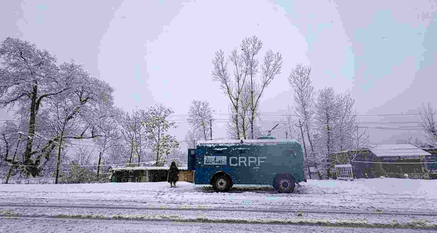  A CRPF jawan keeps watch on Jammu-Srinagar National Highway amid snowfall, at Qazigund in Anantnag district, Jammu and Kashmir on Tuesday. 