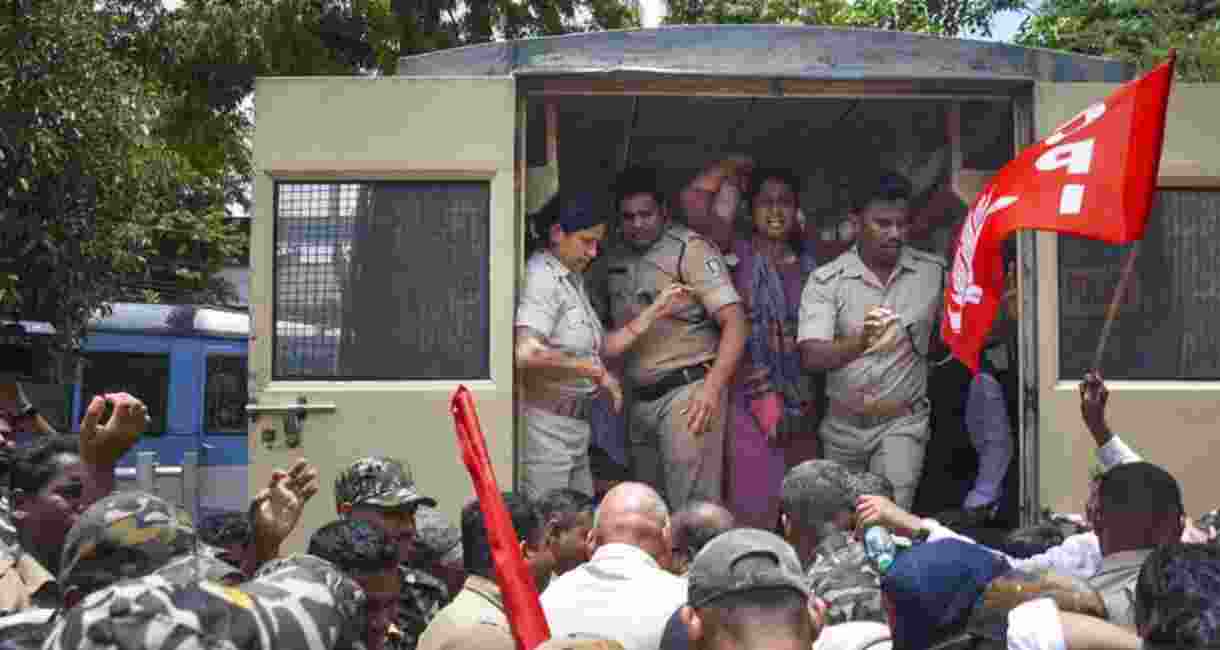 Police detain agitators during a bandh called by several opposition parties in protest over the death of a college student in Odisha