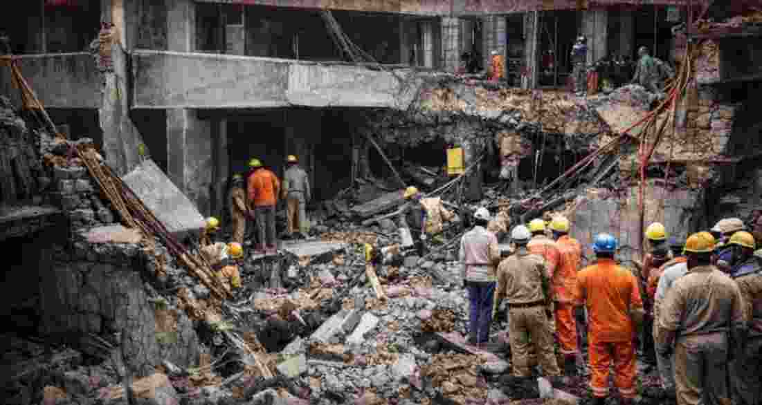 According to officials, the wall suddenly gave way, trapping the workers under heavy debris.