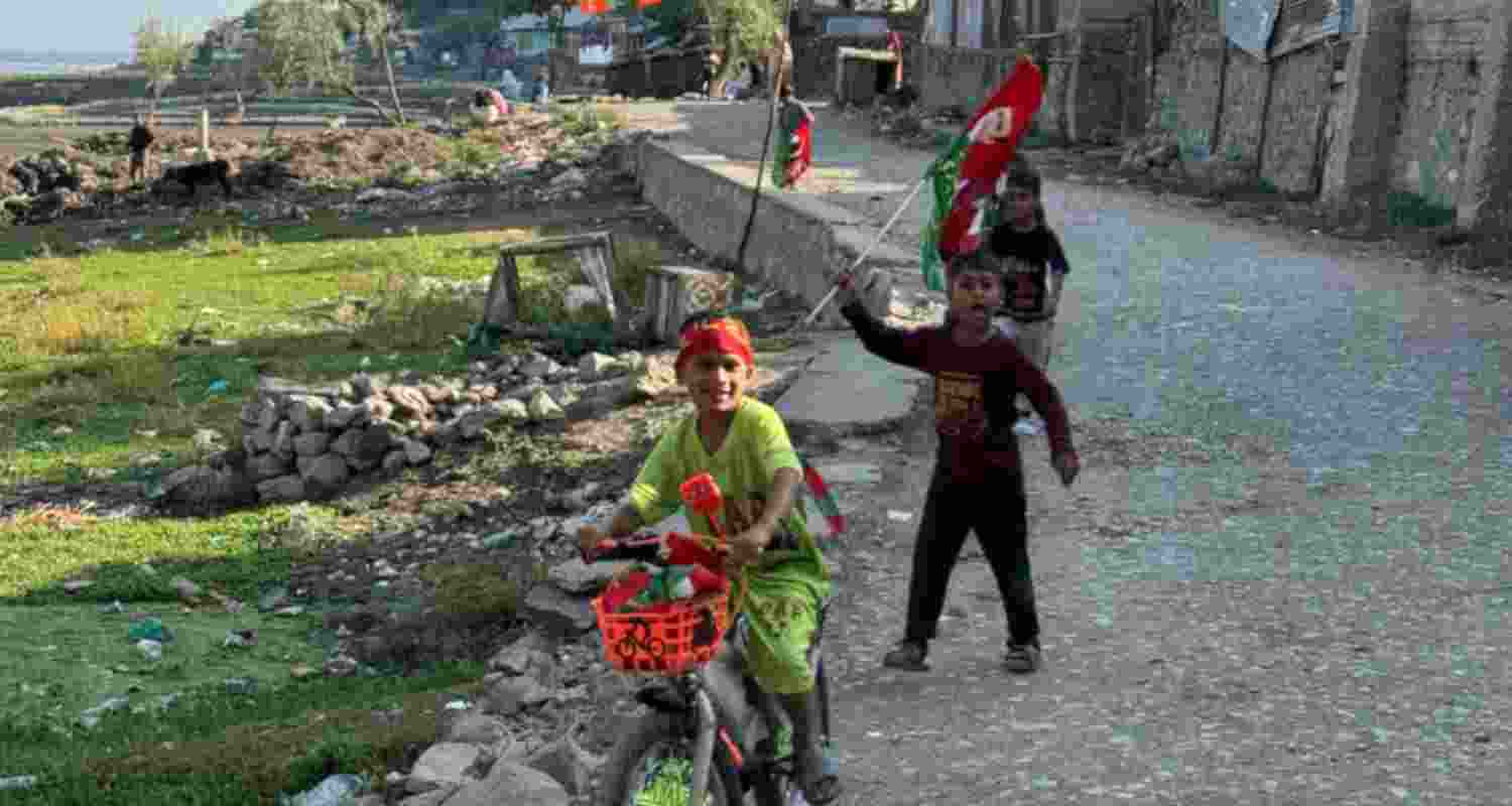 Children play with flags of political parties near the banks of the Wular Lake. Image via Naveen S Garewal.