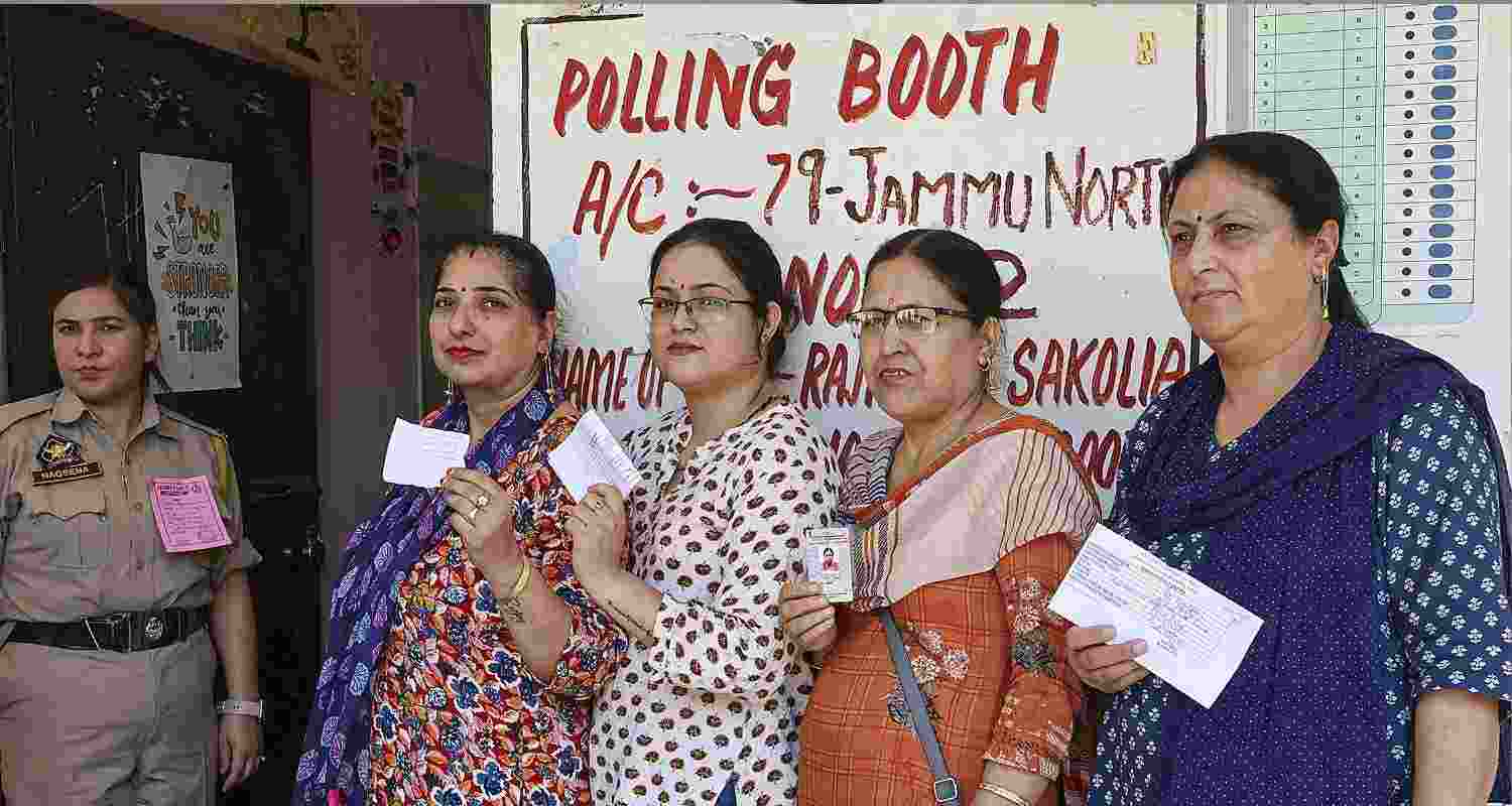 Kashmiri Pandit women lined up for voting at a special poll station for displaced individuals in Jammu.