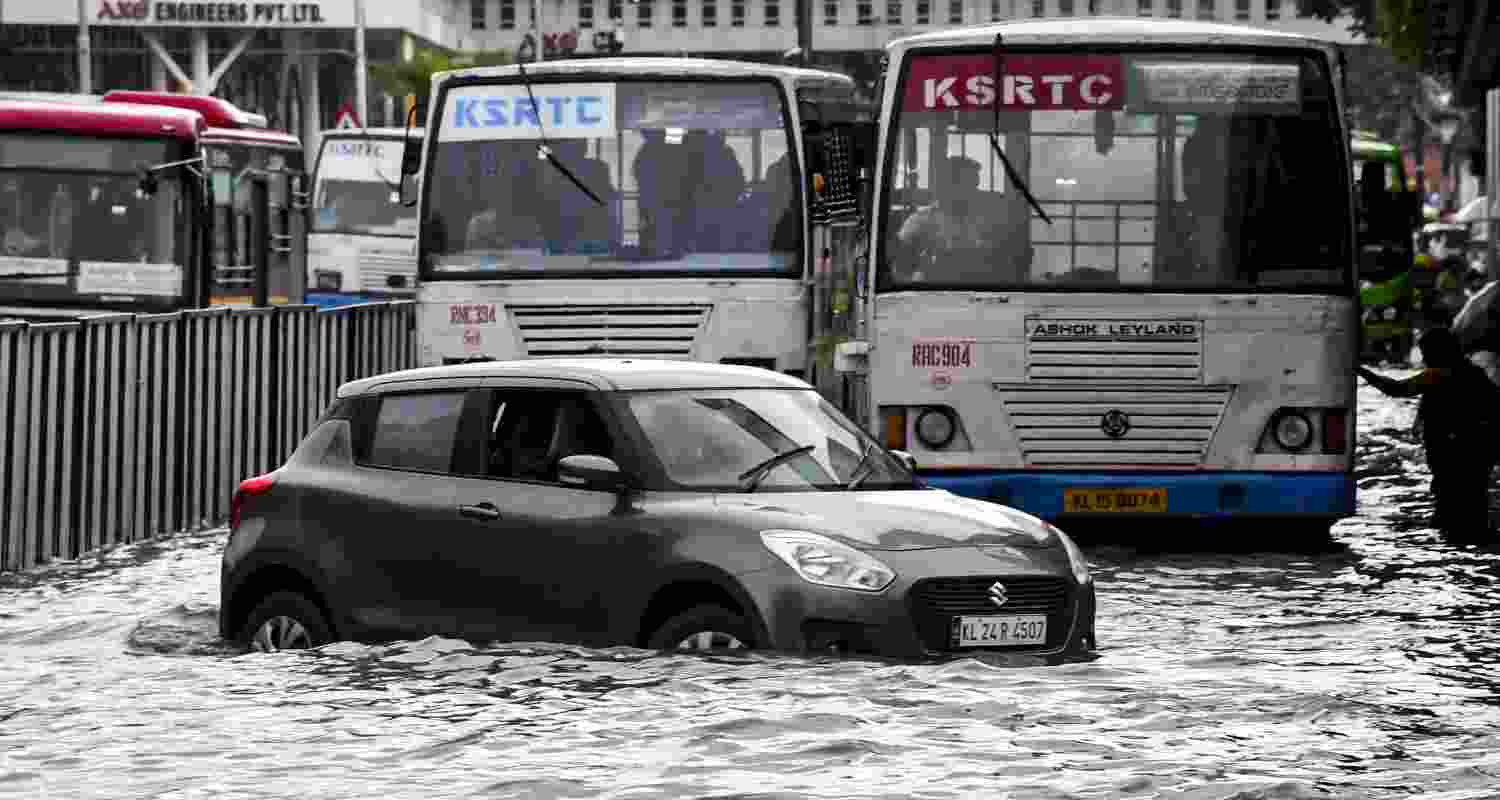 Vehicles wade through a waterlogged road after rainfall, in Thiruvananthapuram, Keralam, Saturday, May 30, 2026.
