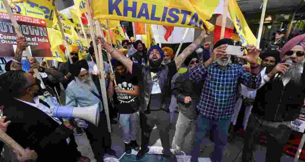 Demonstrators stand on a cardboard cutout of Indian Prime Minister Narendra Modi during a protest outside India's consulate, a week after Canada's Prime Minister Justin Trudeau raised the prospect of New Delhi's involvement in the murder of Sikh separatist leader Hardeep Singh Nijjar.