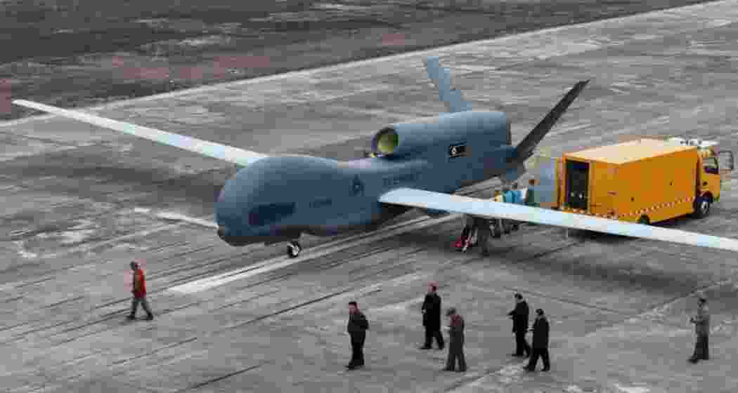 In this image released by the North Korean government on Thursday, 27 March 2025, leader Kim Jong Un is seen inspecting what appears to be a large reconnaissance drone at an undisclosed location in North Korea. Independent verification of the image is not possible. The Korean-language watermark reads “KCNA,” referring to the Korean Central News Agency.