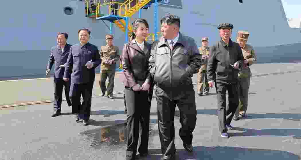 Kim attending a ceremony to launch a new class warship with his daughter Ju-ae, in this undated photo released by the North's official Korean Central News Agency