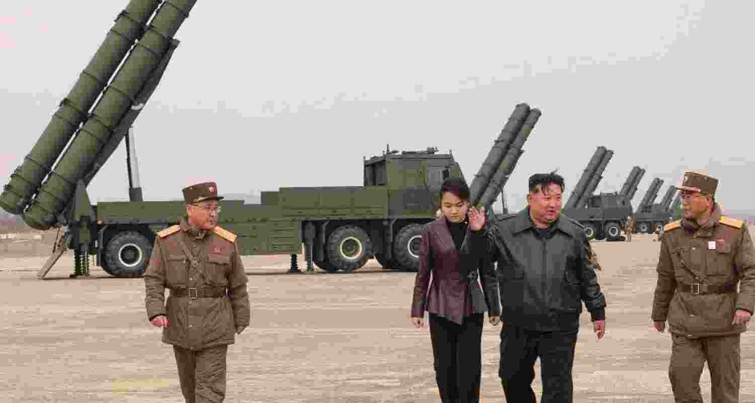 North Korea tests a nuclear-capable rocket launcher with 4,200 km range as Kim Jong Un with daughter oversees launch amid rising tensions with South Korea.