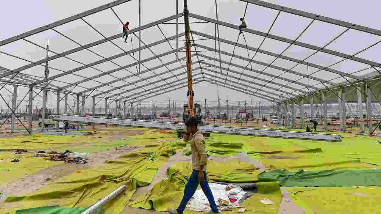Workers dismantle a temporary structure as a part of the cleanup effort after culmination of the 45-day Mahakumbh mela in Prayagraj.