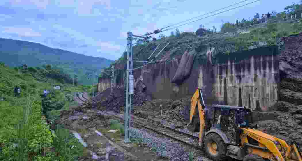 Earthmover clears debris near New Haflong in Assam’s Dima Hasao district, where recurring landslides have buried railway tracks, disrupting train services to Tripura, Mizoram, Manipur, and southern Assam.