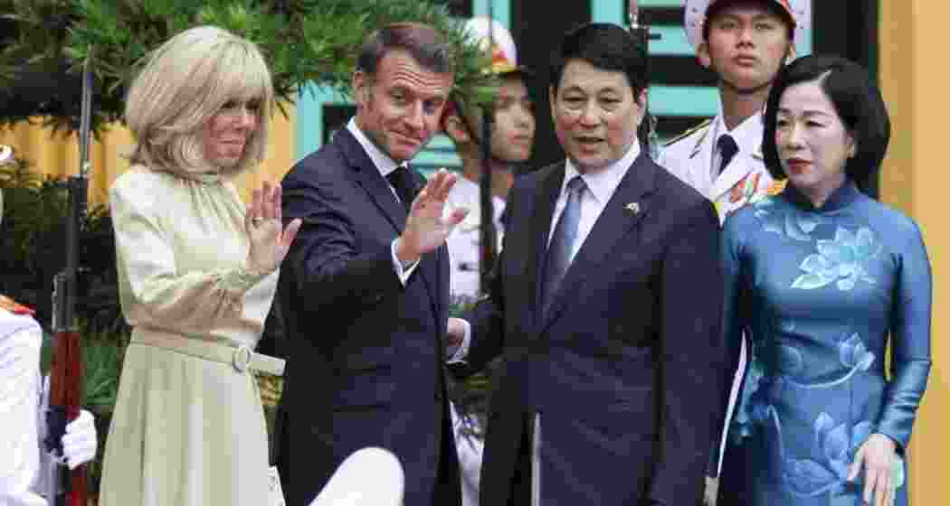 Vietnam’s President Luong Cuong and his wife Nguyen Thi Minh Nguyet welcome French President Emmanuel Macron and his wife Brigitte Macron at the Presidential Palace in Hanoi on Monday.