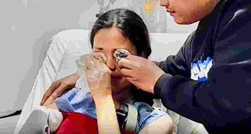 Grieving mother weeps on a hospital bed after her children were killed in the Manipur attack.