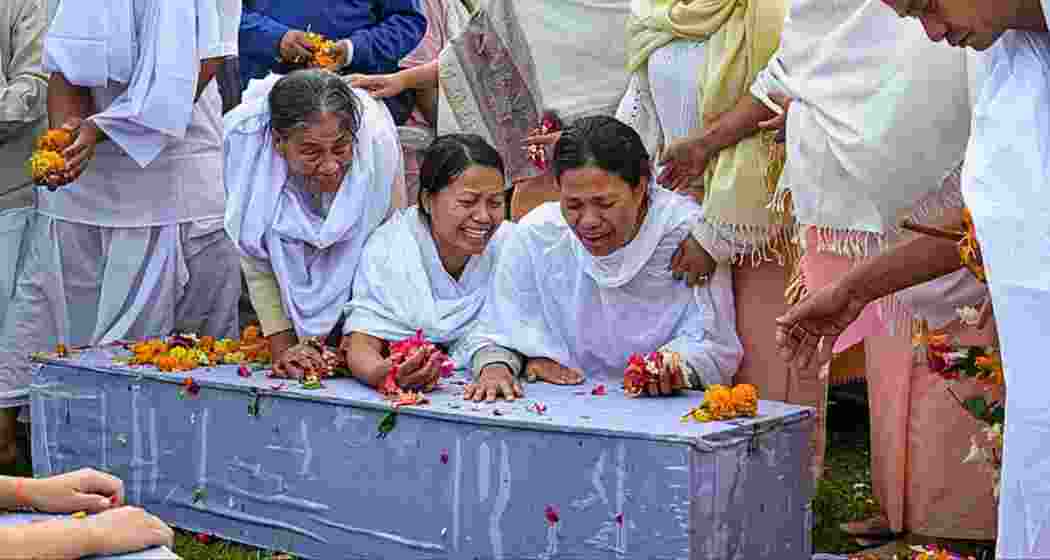 Family members perform the last rites of two children killed in a bomb attack in April in Bishnupur. PTI

