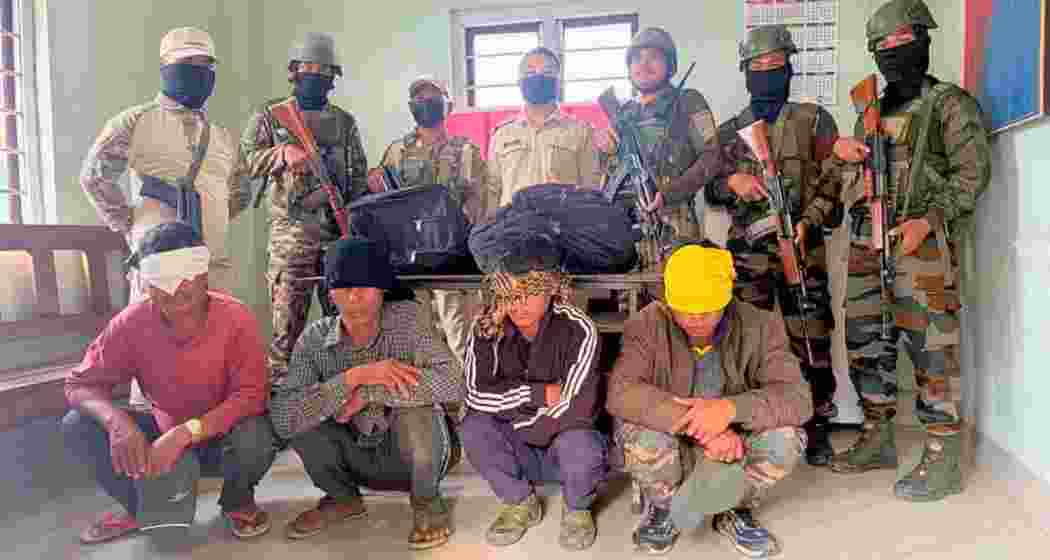 Security personnel with the arrested accused suspected to contain heroin during joint operations in Manipur’s Churachandpur district on Wednesday.