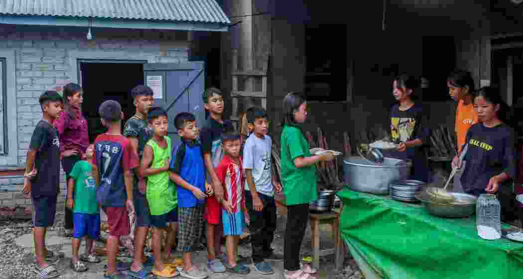 Children wait in queue to receive food at a relief camp in Manipur. 