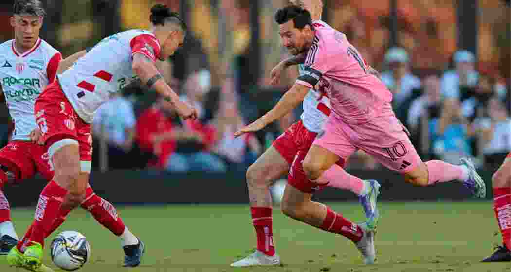 Inter Miami’s Lionel Messi goes down clutching his thigh after a challenge from Necaxa’s Alexis Pena and Raul Sanchez.