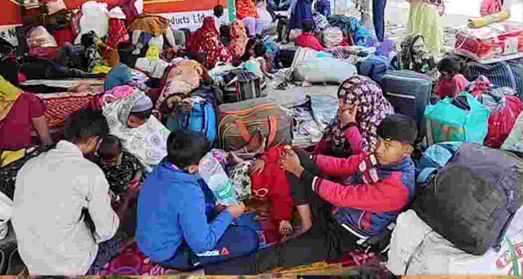 Undocumented Bangladeshi nationals wait with their belongings at the Hakimpur border check-post in North 24 Parganas.
