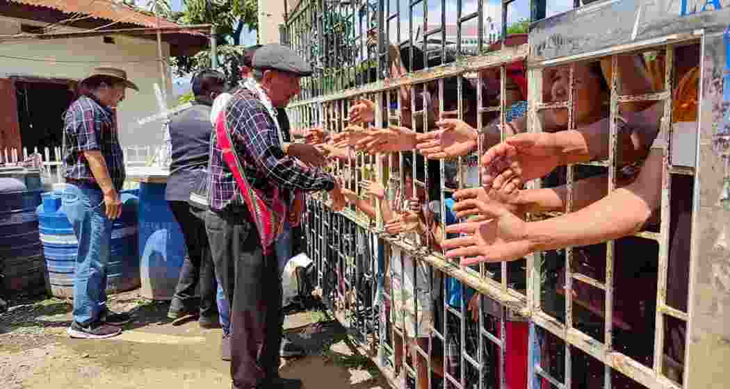 Indian citizens shake hands with Myanmar nationals during a rally against scrapping of the Free Movement Regime (FMR), at Indo-Myanmar Friendship Gate, at Zokhawthar village along India-Myanmar border, in Champhai district of Mizoram on Thursday, May 16, 2024.