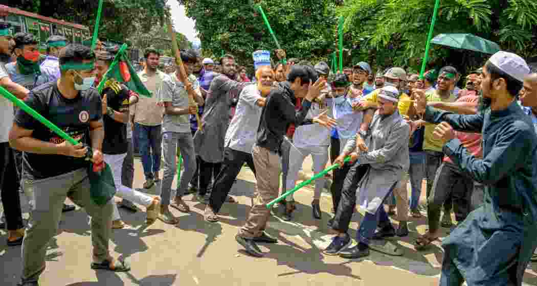 Armed with bamboo sticks and pipes, protesters went after suspected supporters of former Prime Minister Sheikh Hasina as they tried to hold a rally in Dhaka.