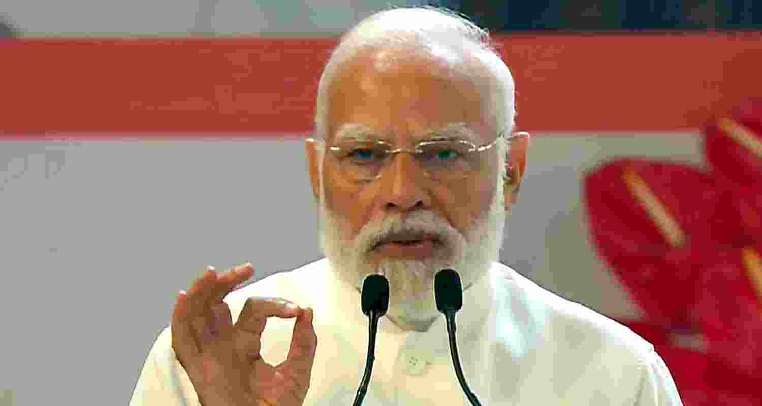 PM Modi greets the gathering during an event marking 150 years of the national song Vande Mataram at the Indira Gandhi Indoor Stadium.