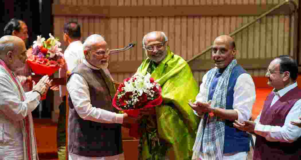 Prime Minister Narendra Modi felicitates Maharashtra Governor and NDA's vice presidential candidate C.P. Radhakrishnan as Defence Minister Rajnath Singh, Union Home Minister Amit Shah, and Union Minister and BJP National President J.P. Nadda applaud during the NDA parliamentary party meeting, in New Delhi.
