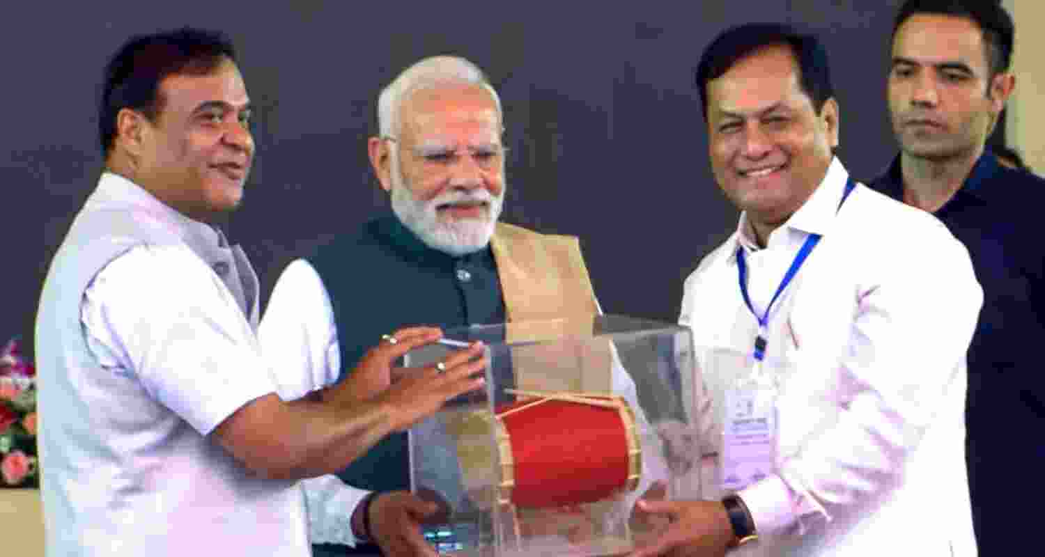 Prime Minister Narendra Modi with Union Minister Sarbananda Sonowal and Assam Chief Minister Himanta Biswa Sarma during a public meeting in Darrang, Assam. 
