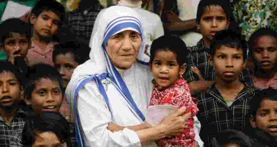 An archival photograph of Mother Teresa with orphaned children, capturing her lifelong commitment to care and compassion.