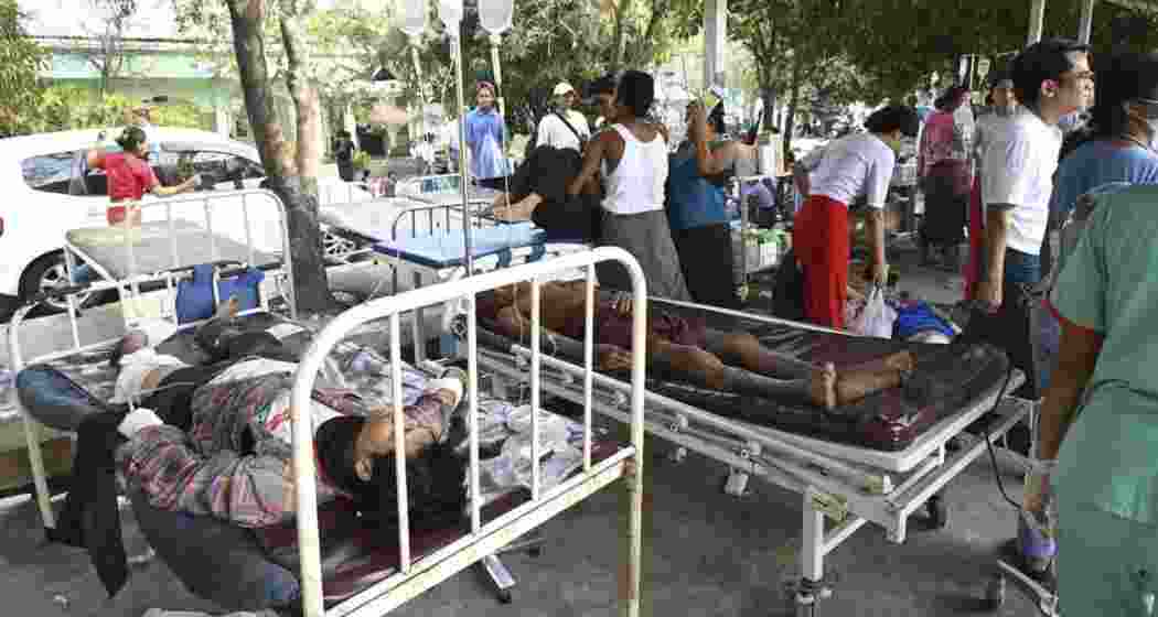 Injured survivors receive medical aid at a temporary shelter after a powerful earthquake struck Myanmar on Friday, claiming at least 694 lives. Tremors were felt in India, Bangladesh, and China.
