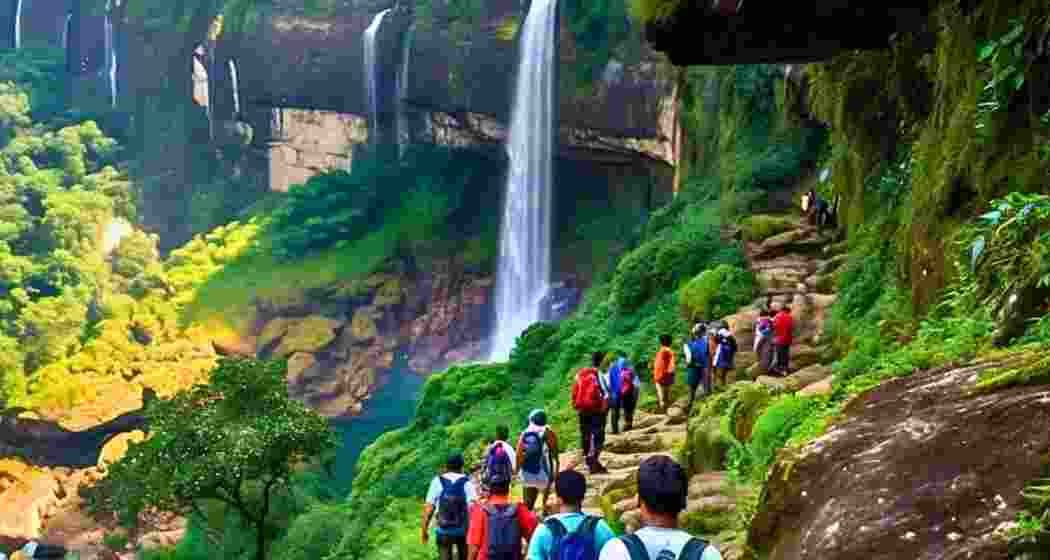 Tourists trek to the breathtaking Seven Sisters Waterfall, also known as Nohsngithiang Falls or Mawsmai waterfall site in Meghalaya.
