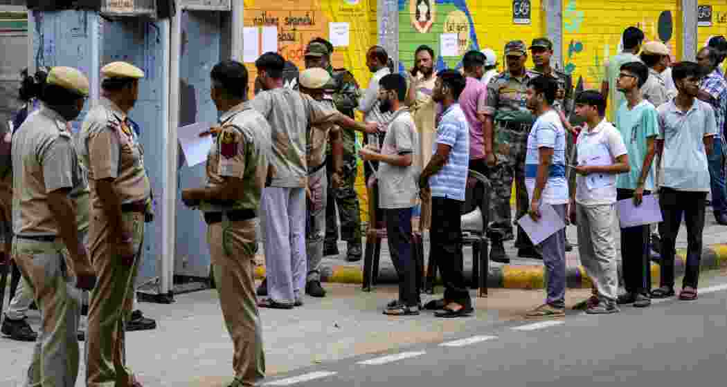 NEET-UG candidates undergo security screening before entering an examination centre, in New Delhi, Sunday, June 21, 2026. The Re-NEET UG 2026 examination is being conducted following the cancellation of the original test held on May 3 amid a paper leak controversy.
