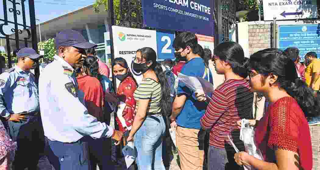 Students are being screened at entry points, with IDs and security checks before entering the examination centre. 