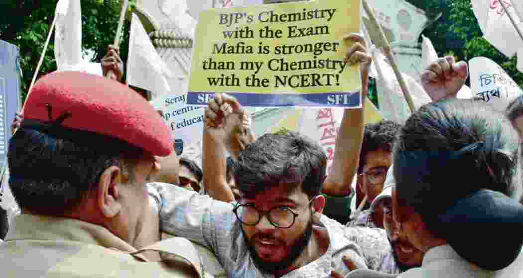 SFI members scuffles with police during a protest in front of Cotton University against the leakage of NEET-UG question papers, in Guwahati. (Photo: ANI)