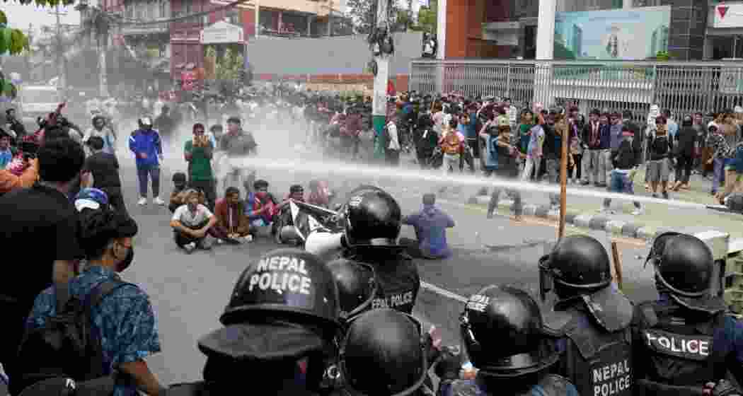 Protesters shout slogans as they gather outside the Parliament building in Kathmandu, Nepal, Monday.