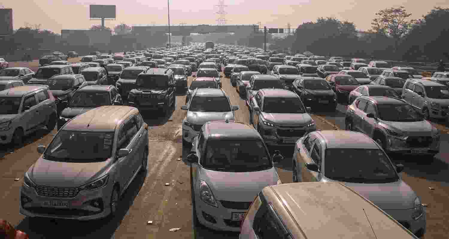 Vehicles stuck in a traffic jam on Delhi-Noida Direct Flyway after security was heightened in view of farmers' protest march towards the national capital, in Noida, Monday.