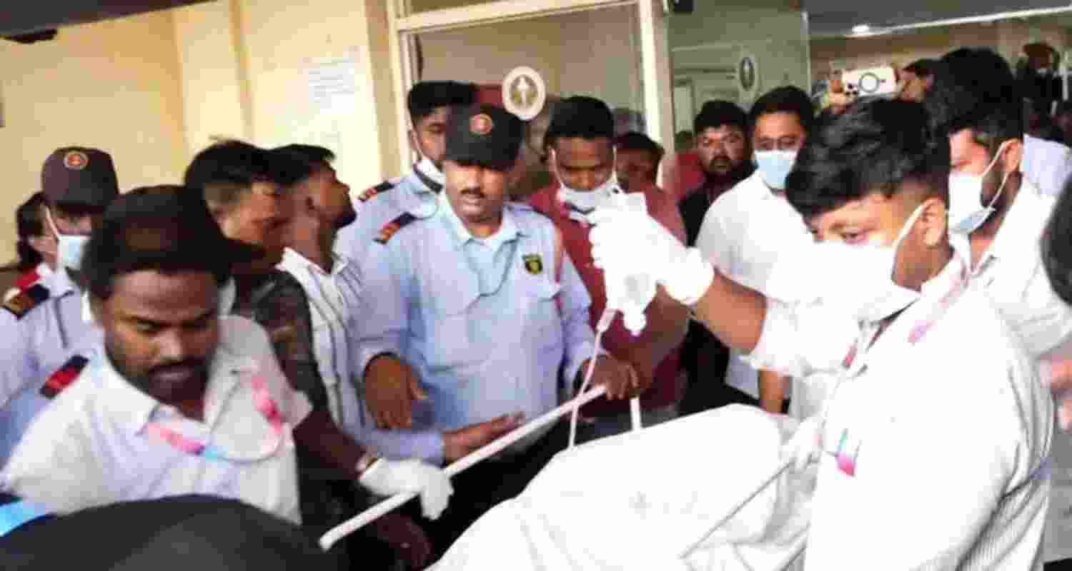 A file photo of medical staff in Odisha hospital bringing out the victim girl to be airlifted to Delhi. 