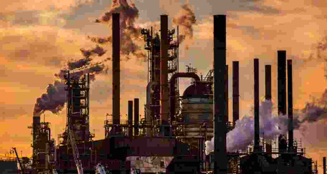 An oil manufacturing facility releasing dense plumes of smoke into the air. (Representative image).