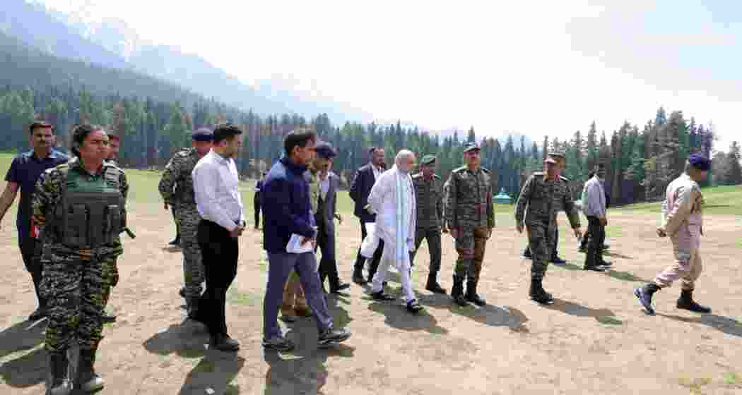 Union Home Minister Amit Shah reviews the Pahalgam meadow with senior Indian Army officials during a visit to the site.