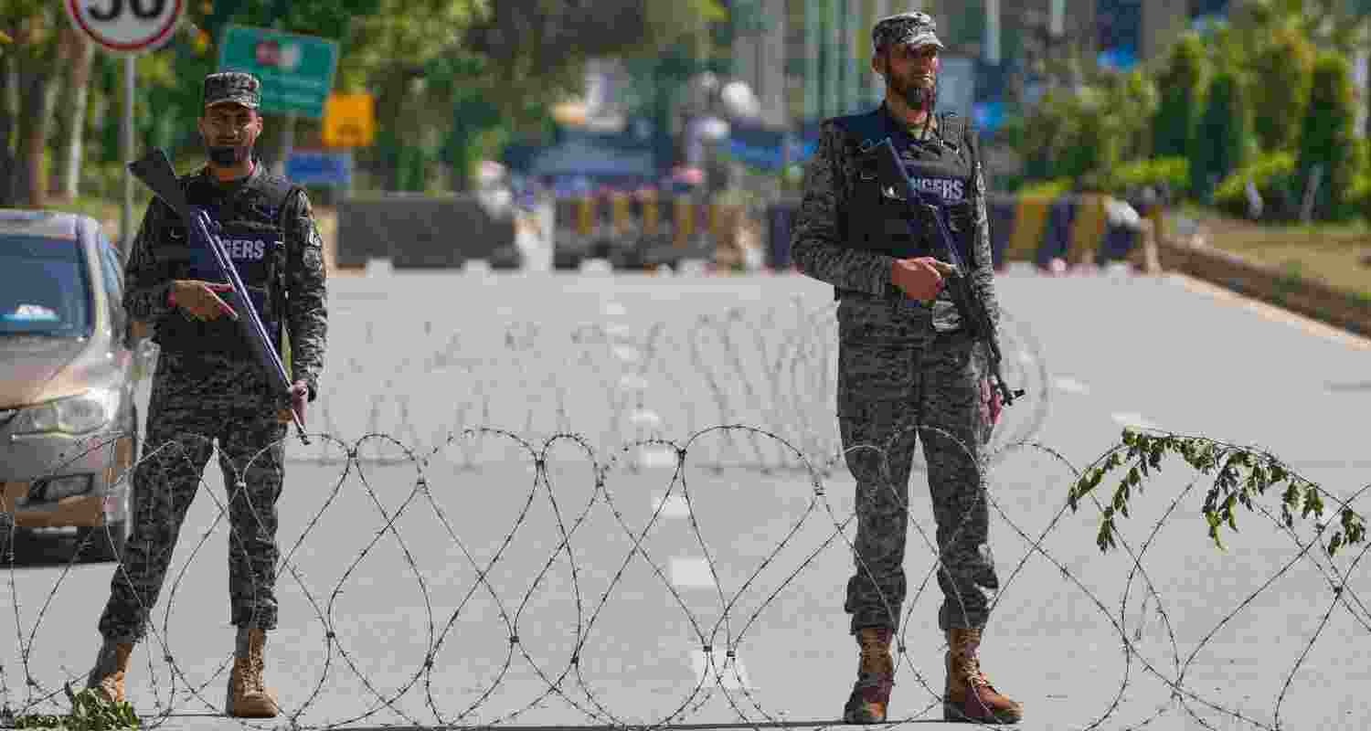 Soldiers stand guard at a checkpoint to ensure security ahead of the United States and Iran possible negotiations in Pakistani capital. 