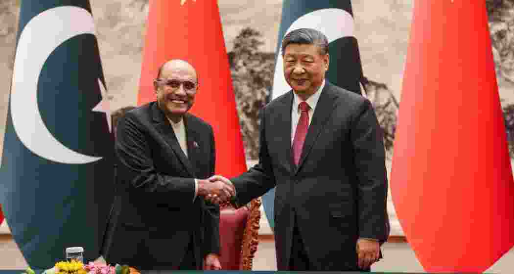 Chinese President Xi Jinping, right, shakes hands with Pakistani President Asif Ali Zardari at the Great Hall of the People in Beijing, China.