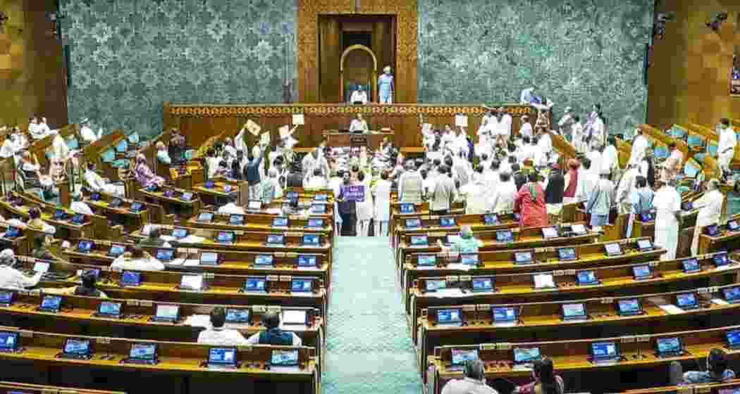 Opposition MPs protest in the Lok Sabha during the Monsoon session of Parliament.