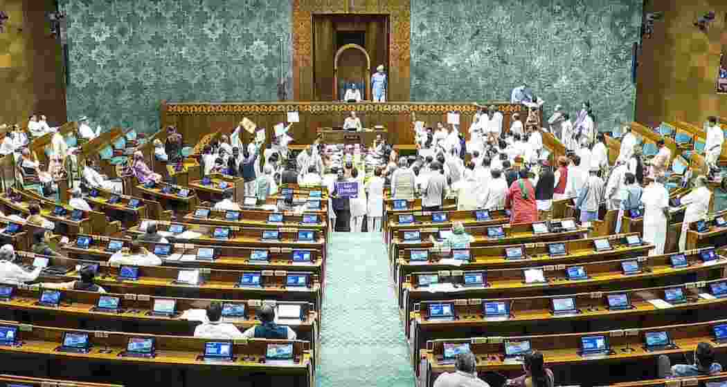 Opposition MPs protest in the Lok Sabha during the Monsoon session of Parliament, in New Delhi on Friday. Opposition MPs protest in the Lok Sabha during the Monsoon session of Parliament, in New Delhi on Friday.