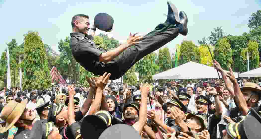 Newly-inducted officers celebrate after the Passing Out Parade of the Indian Military Academy (IMA), in Dehradun, Saturday.
