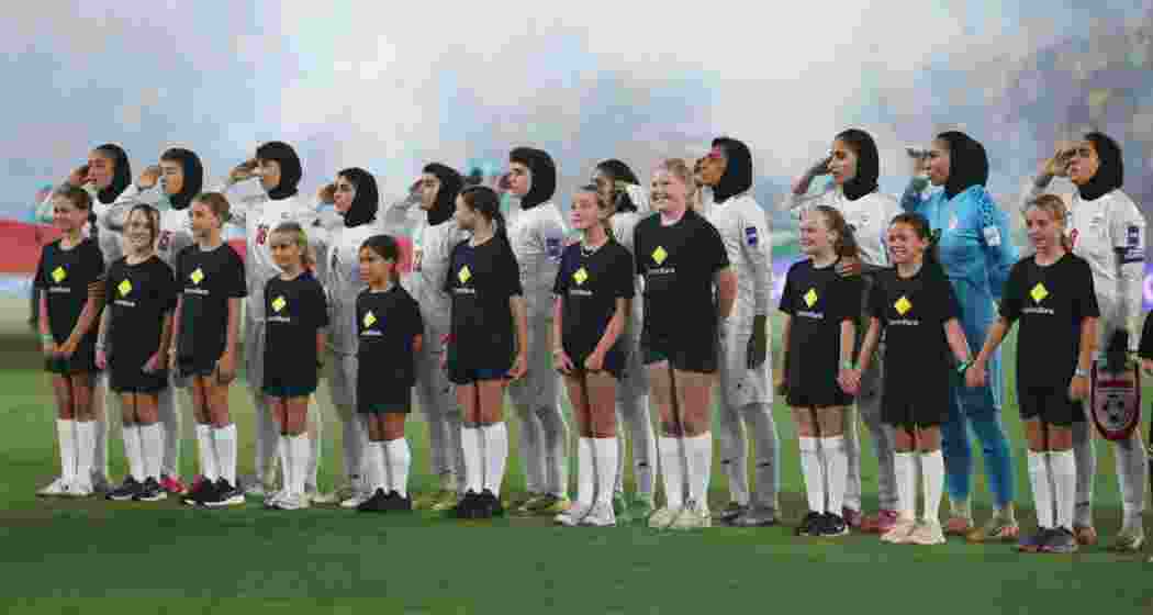The Iranian women's football team singing and saluting as their national anthem was played ahead of the Women’s Asian Cup contest against Australia in Gold Coast on Thursday.
