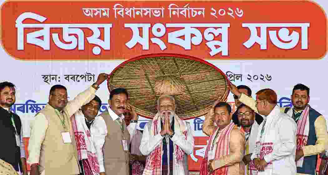 Prime Minister Narendra Modi, centre, being felicitated during a public meeting ahead of the Assam Assembly elections, in Barpeta, Assam, on Monday.