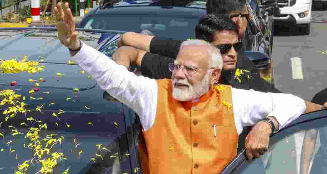 In this image made available from PMO, Prime Minister Narendra Modi waves at supporters during a roadshow in Vadodara, Gujarat, Monday, 26 May, 2025.