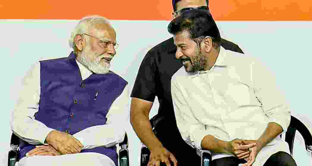  Prime Minister Narendra Modi, left, interacts with Telangana Chief Minister A Revanth Reddy during a public meeting, in Hyderabad, Telangana on Sunday.