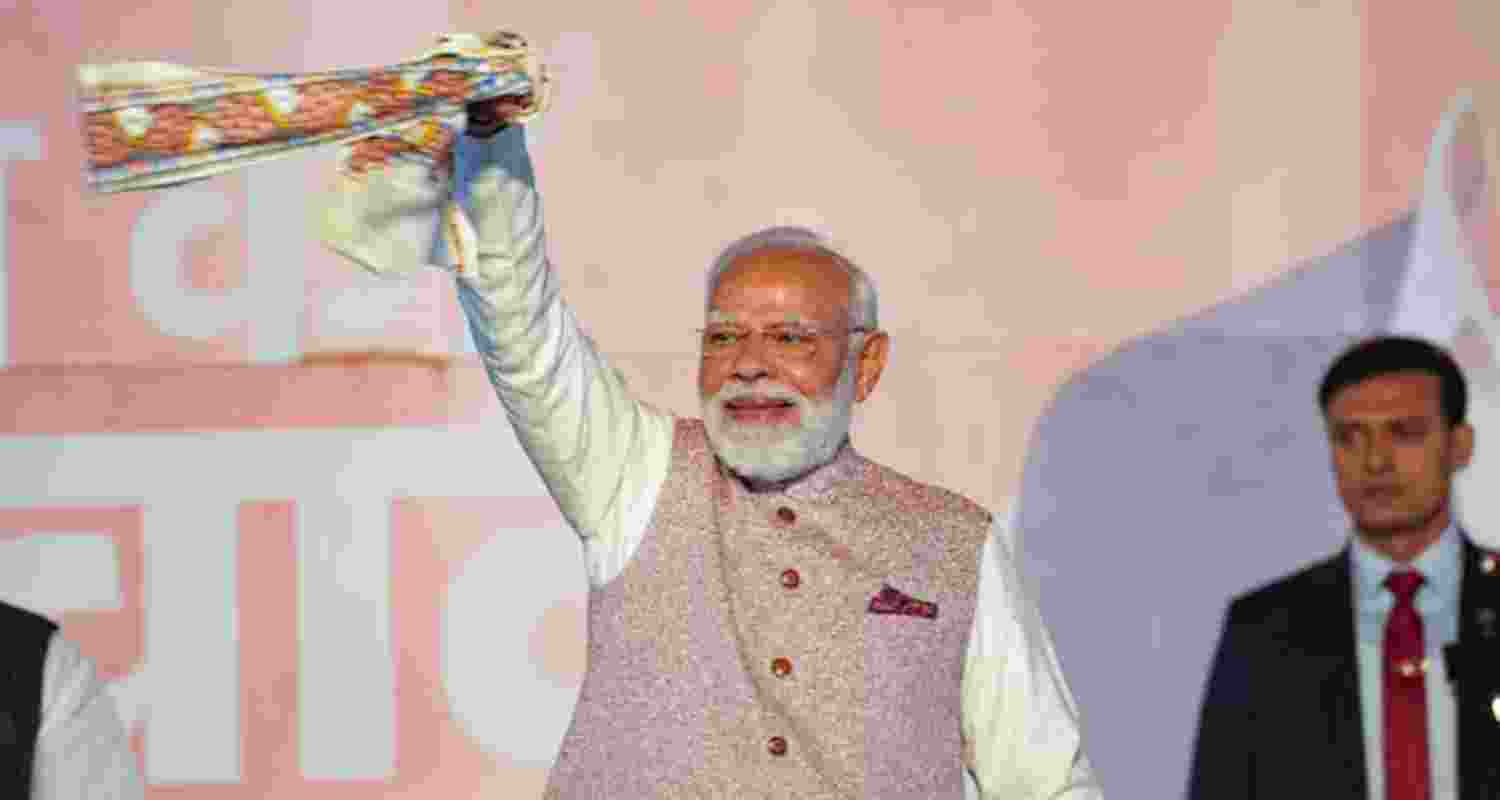 Prime Minister Narendra Modi's gesture towards the party workers and supporters during the victory speech at the BJP headquarters in Delhi on Friday.