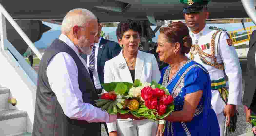 Kamla Persad-Bissessar welcomes Narendra Modi with traditional Indian hospitality at Piarco International Airport in Port of Spain, Trinidad and Tobago, on July 4, 2025.