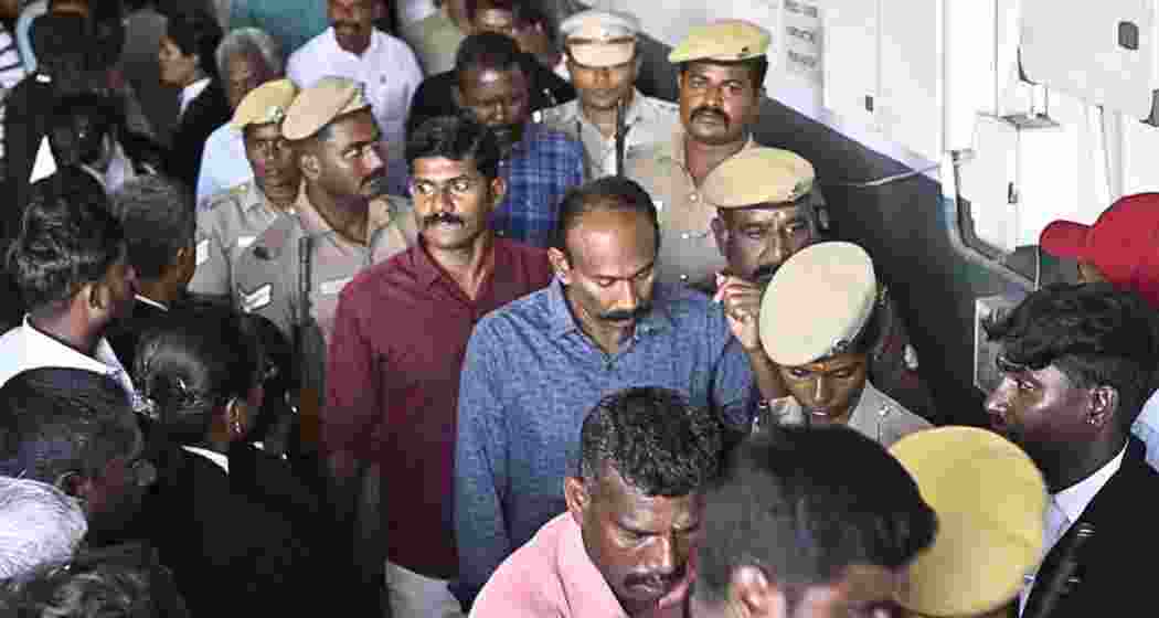 Convicted police personnel are escorted by security officials before being produced in a court in Madurai following the verdict in the Sathankulam custodial deaths case. 