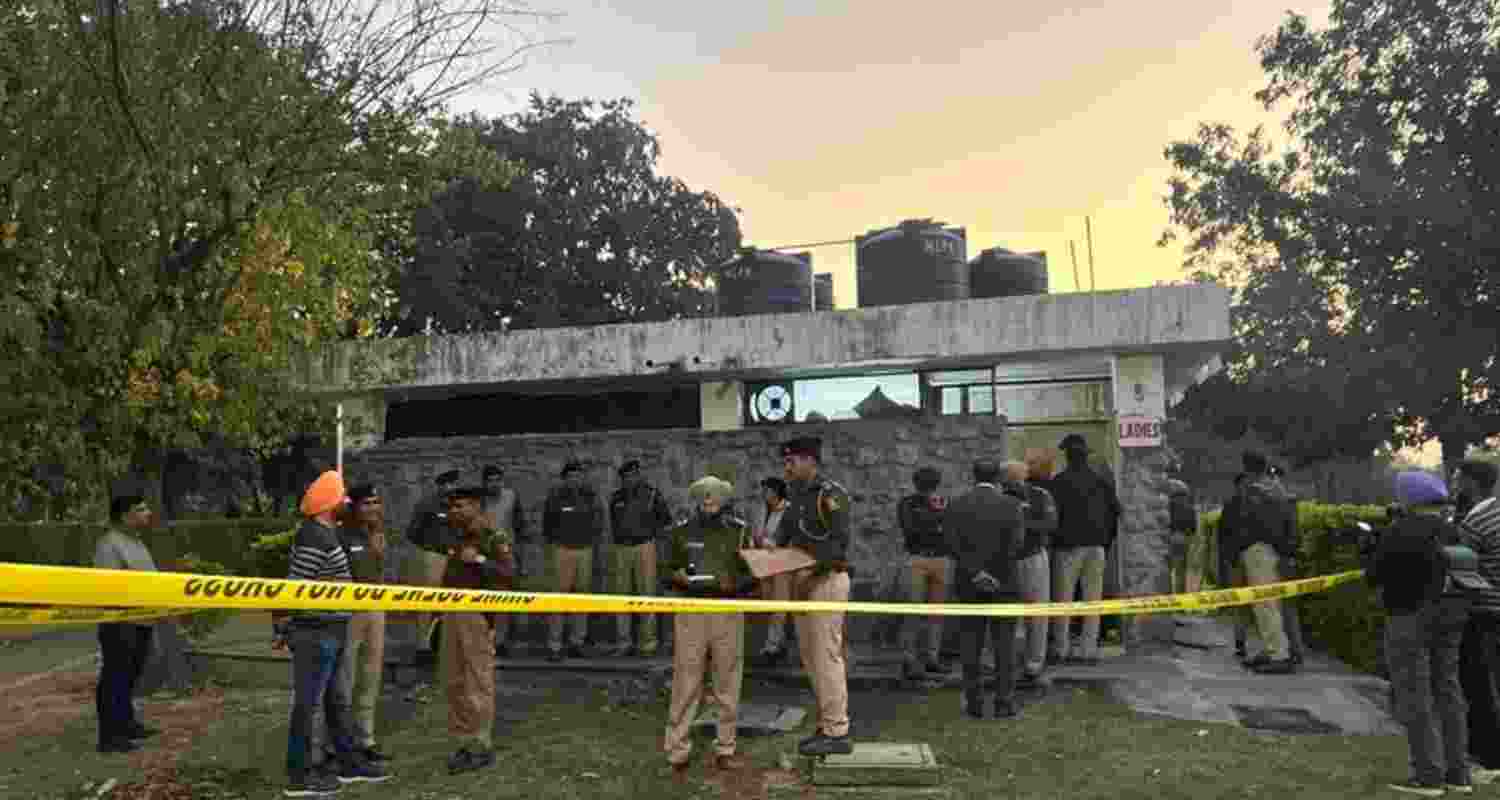 Police officials examining the scene of crime after cordoning off the area.