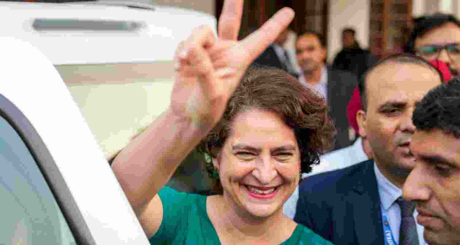 Congress General Secretary Priyanka Gandhi Vadra flashes victory sign as she leaves after meeting party President Mallikarjun Kharge following her massive victory in the Wayanad Lok Saha by-poll, in New Delhi, Saturday.